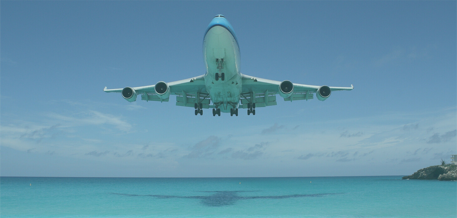 picture of a plane flying over the sea